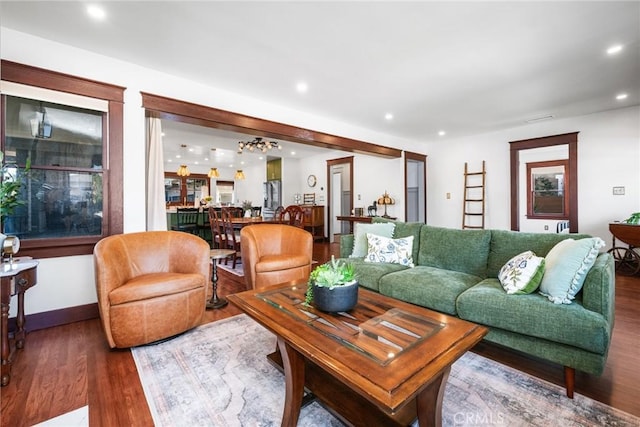 living area featuring recessed lighting, baseboards, and wood finished floors