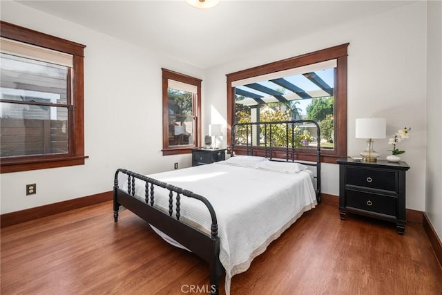 bedroom featuring wood finished floors and baseboards