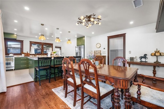 dining area featuring light wood finished floors, visible vents, and recessed lighting