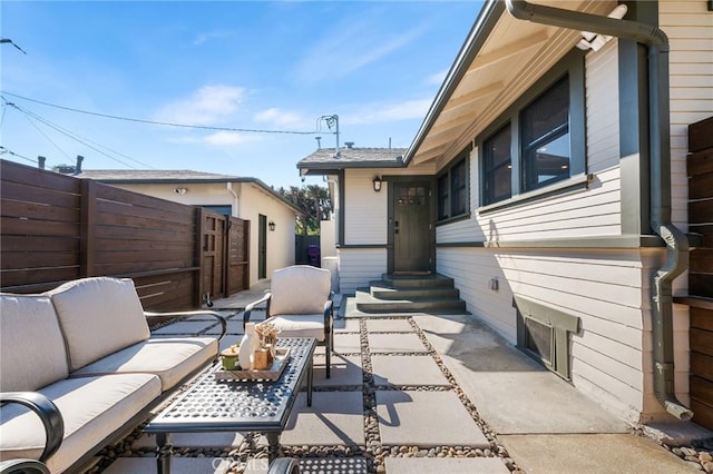 view of patio / terrace with entry steps, fence, and an outdoor hangout area