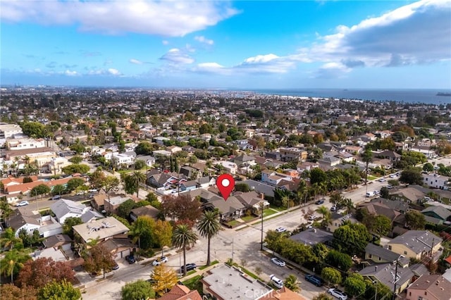 drone / aerial view featuring a water view and a residential view