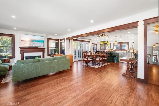 living room featuring recessed lighting, a fireplace, and light wood-style floors