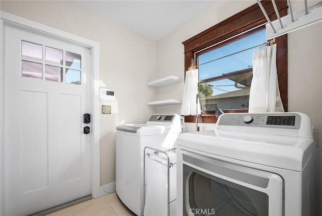 laundry area featuring laundry area, light tile patterned flooring, and separate washer and dryer