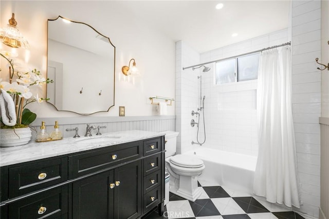 bathroom with wainscoting, shower / bath combo, vanity, and toilet