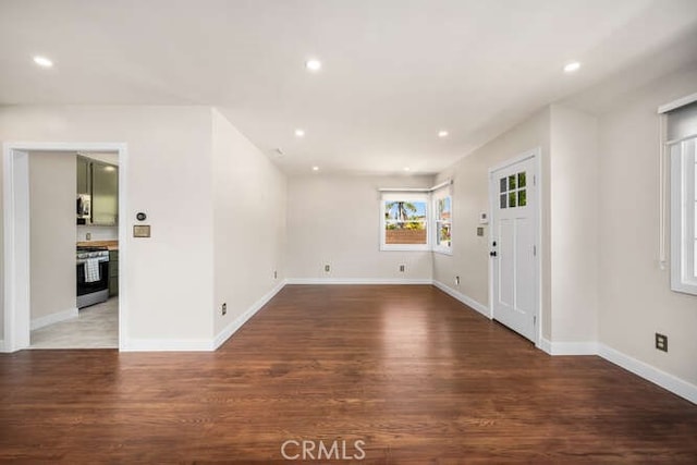 foyer entrance with baseboards, wood finished floors, and recessed lighting