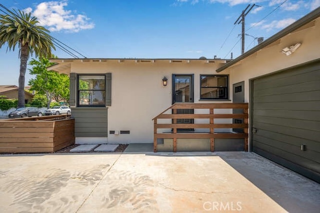 back of house featuring a patio and stucco siding