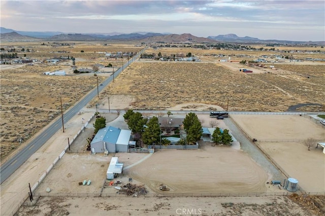 birds eye view of property featuring a rural view, a desert view, and a mountain view