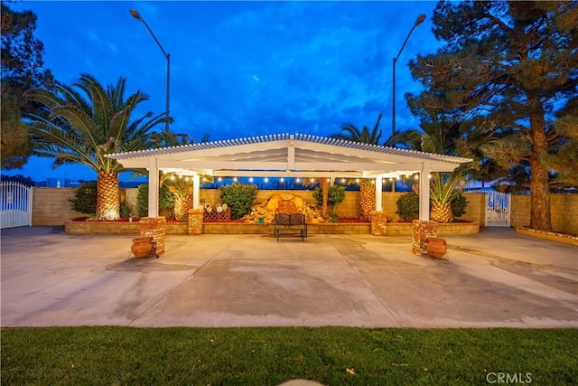 view of patio / terrace featuring a gate, fence, and a pergola