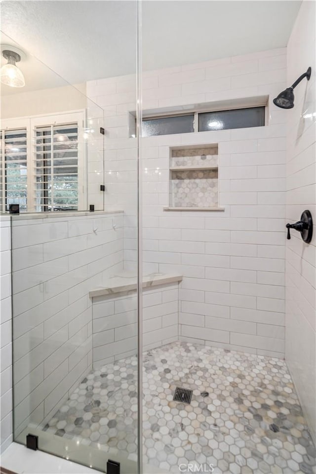 full bath with a shower stall