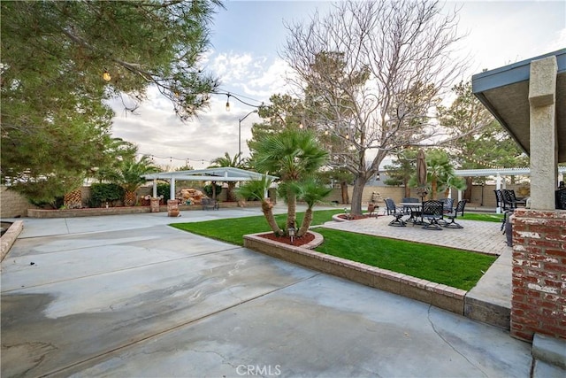 exterior space featuring a patio area, a pergola, and a yard