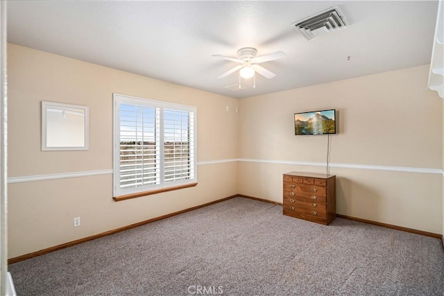 empty room featuring carpet flooring, visible vents, and baseboards