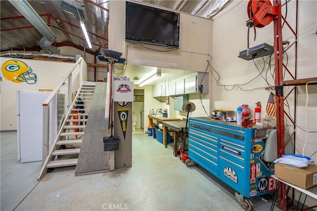 basement featuring stairs and a workshop area