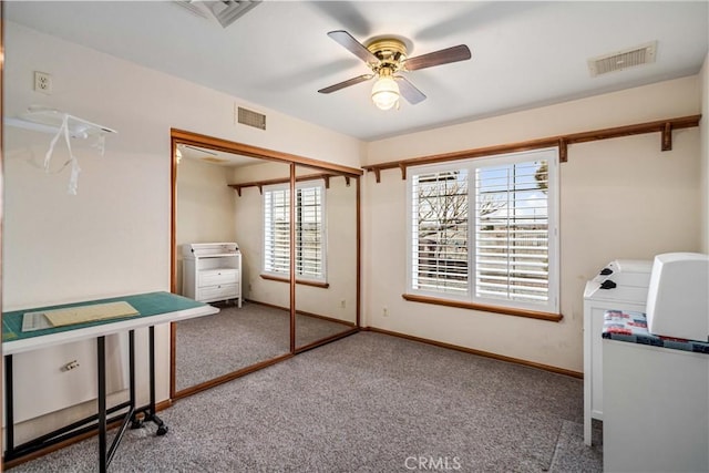 unfurnished office featuring baseboards, carpet, visible vents, and a ceiling fan