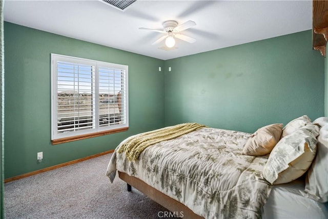 carpeted bedroom featuring visible vents, ceiling fan, and baseboards