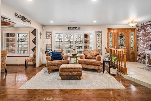 sitting room with recessed lighting, wood-type flooring, plenty of natural light, and baseboards