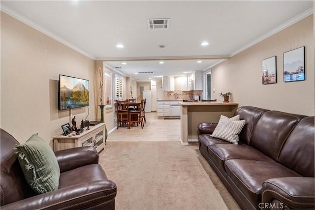 living area with ornamental molding, recessed lighting, visible vents, and light carpet