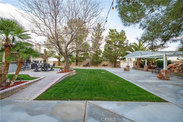 view of yard featuring a patio, a fenced backyard, and a pergola