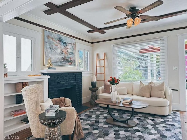 sitting room with ceiling fan, a fireplace, crown molding, and wood finished floors