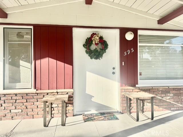 view of exterior entry featuring brick siding