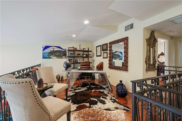 home office featuring lofted ceiling, wood finished floors, visible vents, and recessed lighting