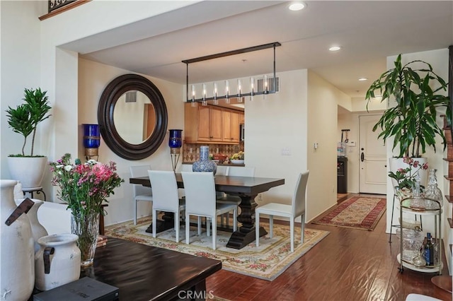 dining area with dark wood-style floors and recessed lighting