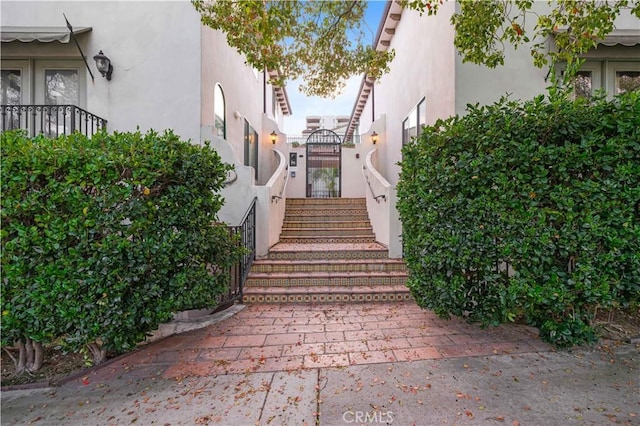 property entrance with stucco siding