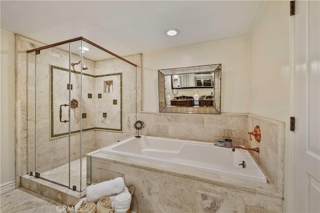 full bathroom with a shower stall and a bath