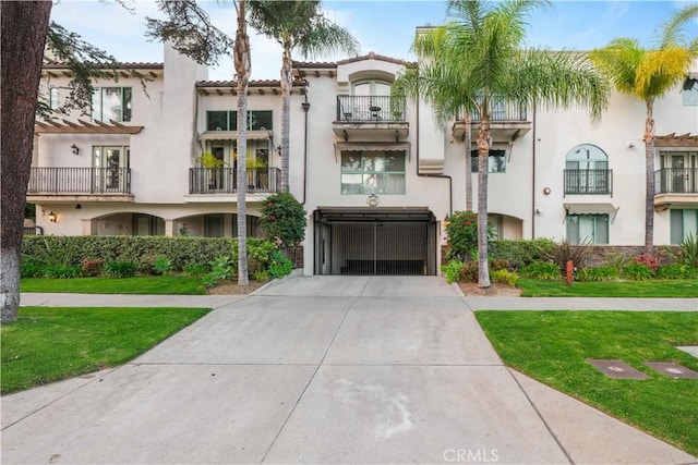 view of property featuring a garage and concrete driveway