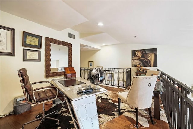 office space featuring lofted ceiling, wood finished floors, visible vents, and recessed lighting