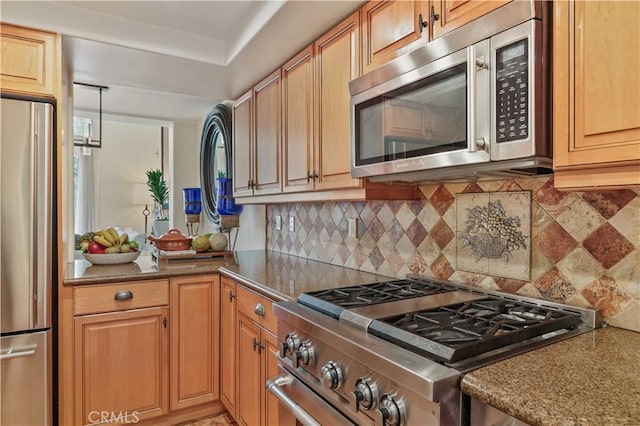 kitchen featuring appliances with stainless steel finishes and tasteful backsplash