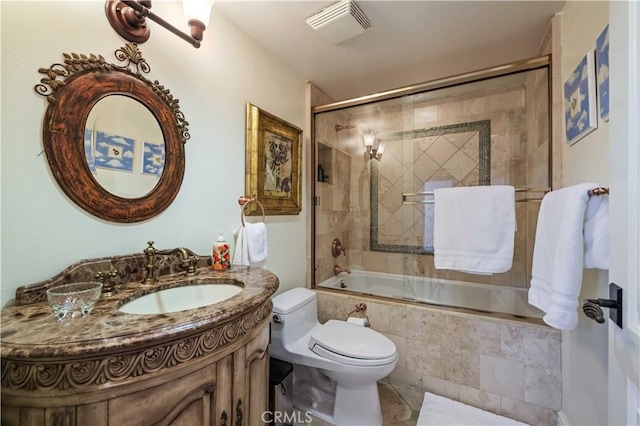 full bath with toilet, tiled shower / bath, visible vents, and vanity