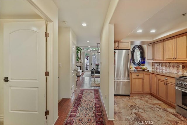 interior space with appliances with stainless steel finishes, a wealth of natural light, backsplash, and recessed lighting