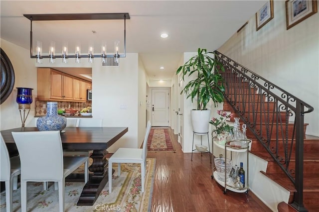 dining room featuring stairway, wood finished floors, and recessed lighting