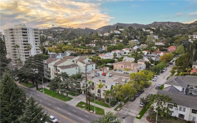 aerial view at dusk featuring a mountain view