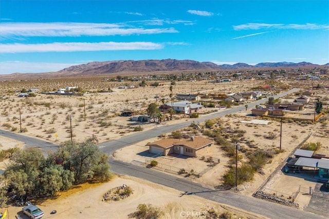 birds eye view of property featuring a mountain view, a rural view, and view of desert