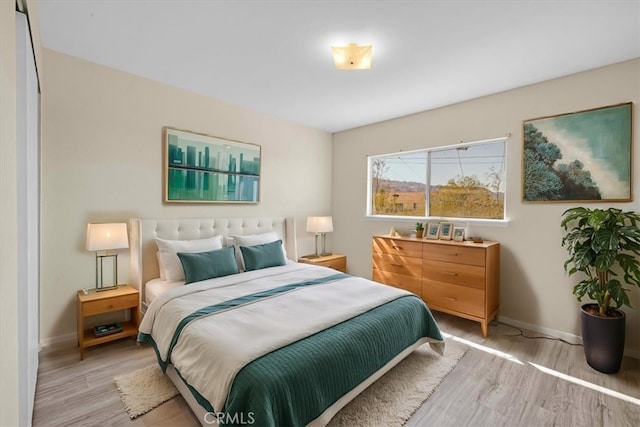 bedroom with wood finished floors and baseboards