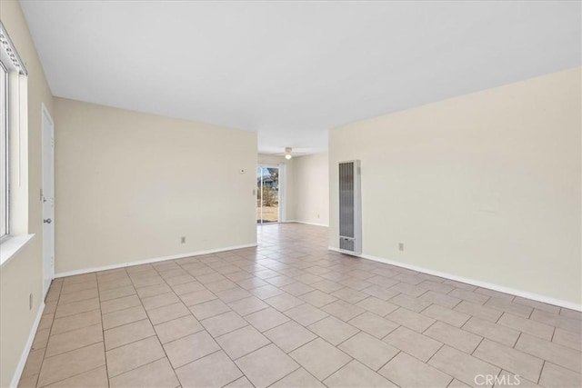 unfurnished room featuring baseboards and ceiling fan