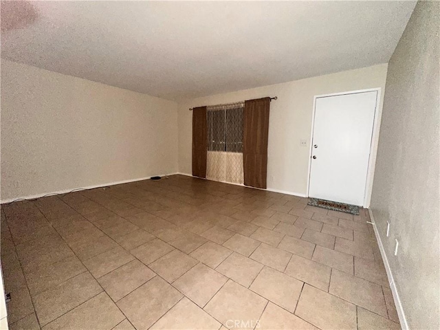 empty room featuring baseboards