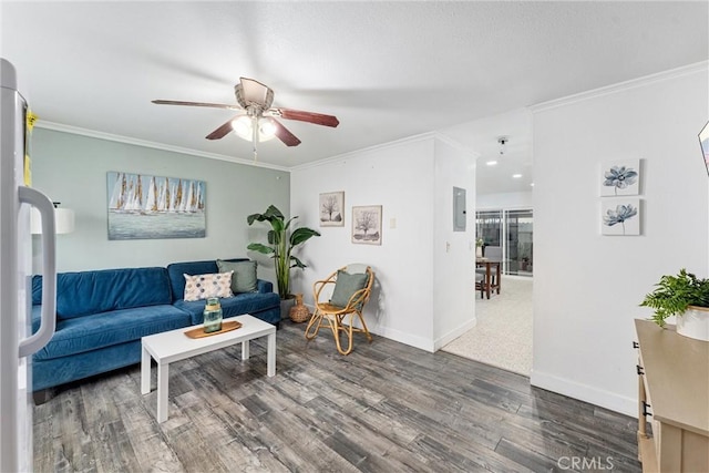 living room with ceiling fan, wood finished floors, baseboards, electric panel, and crown molding