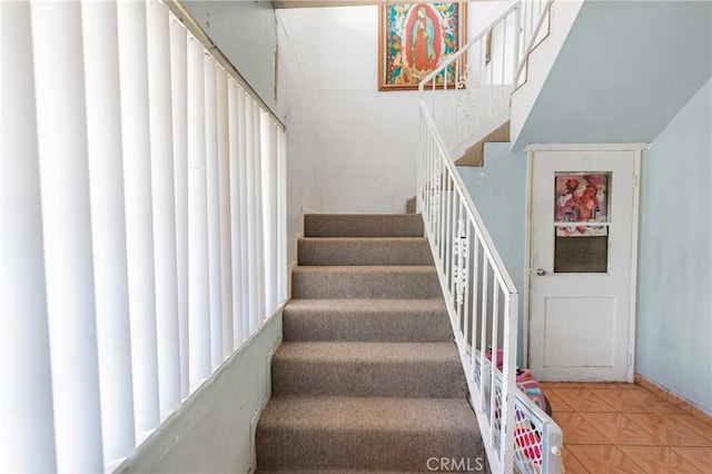 stairs with tile patterned flooring and plenty of natural light