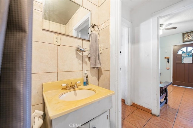 bathroom with vanity, tile walls, a ceiling fan, and tile patterned floors