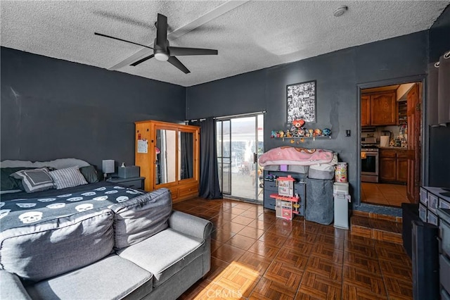 bedroom featuring a textured ceiling, access to exterior, and a ceiling fan