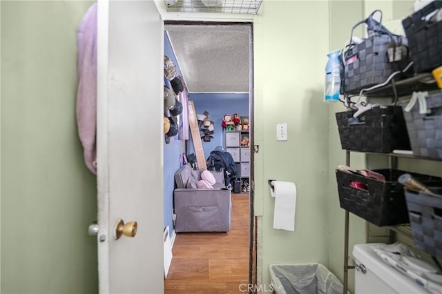 walk in closet with wood finished floors