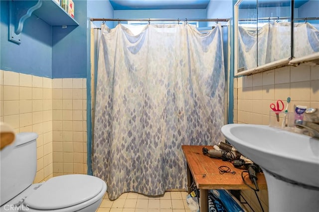 full bath with a shower with curtain, toilet, tile walls, and tile patterned flooring