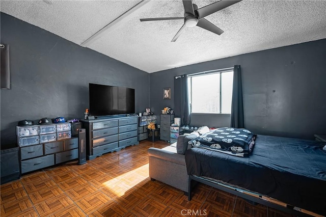 bedroom featuring a textured ceiling, a ceiling fan, and vaulted ceiling