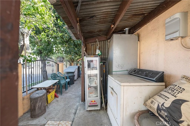 view of patio / terrace with washer / clothes dryer and fence