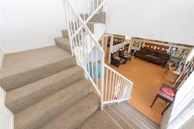 stairs featuring carpet and baseboards