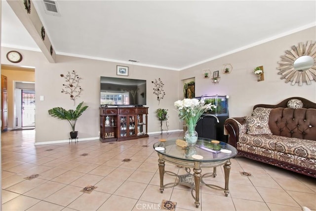 living room featuring visible vents, light tile patterned flooring, and ornamental molding