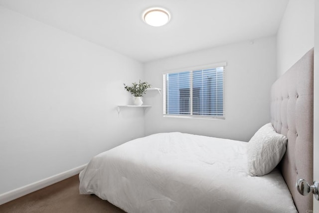 bedroom with carpet floors and baseboards