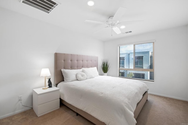 bedroom featuring light carpet, visible vents, and baseboards